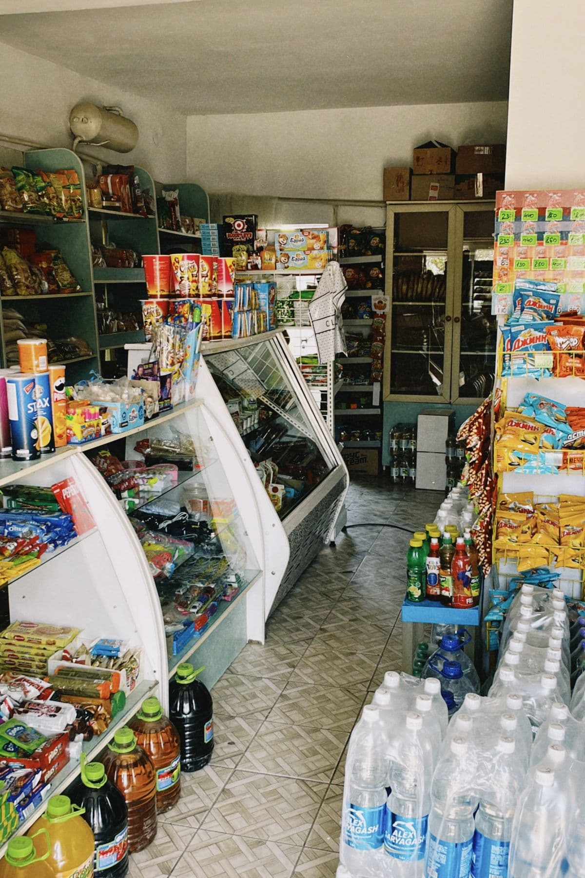 Shelves inside a small grocery shop stocked with everyday products