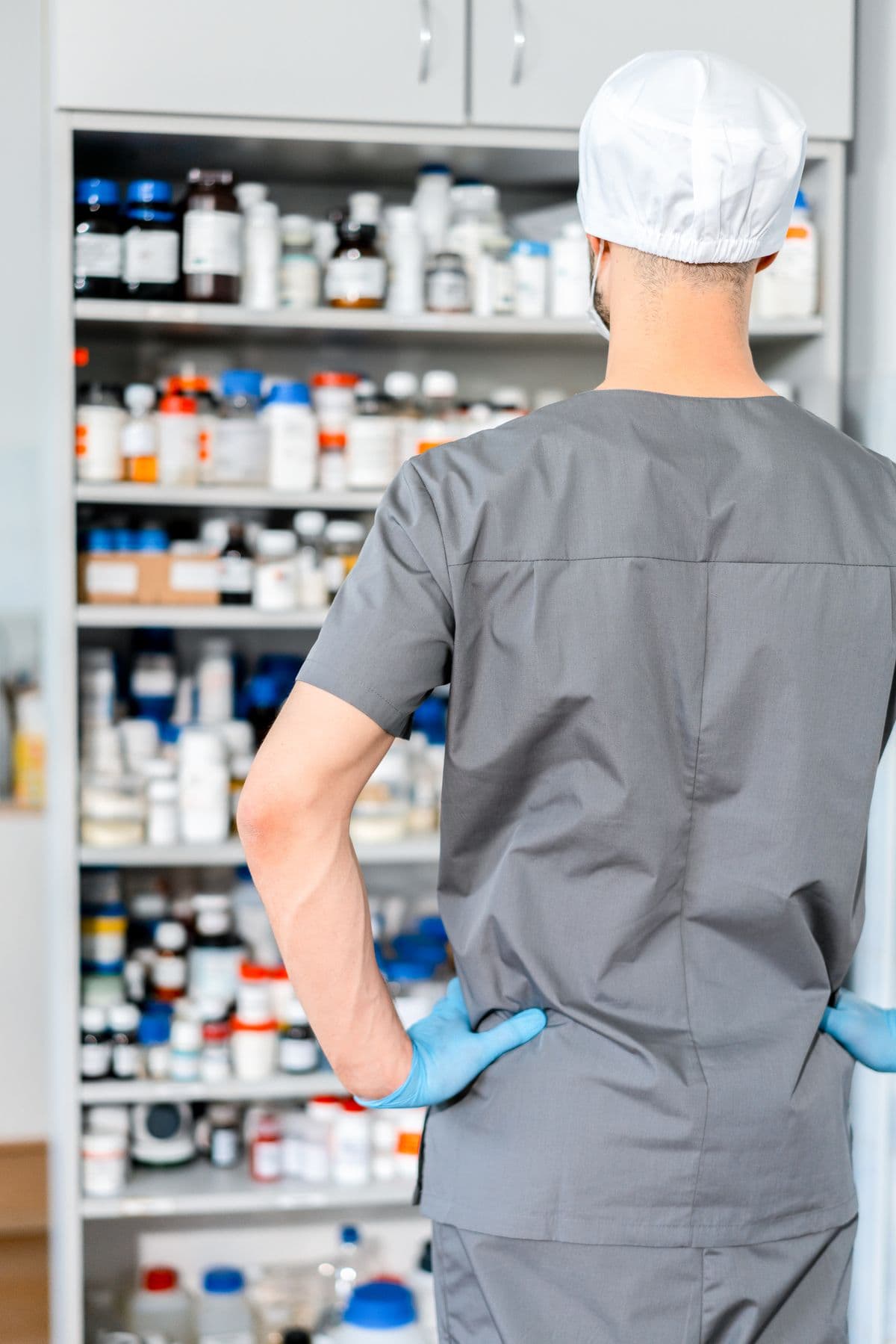 Pharmacist organizing medicine on shelves in a pharmacy